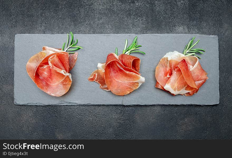 Italian Prosciutto Crudo Or Spanish Jamon. Raw Ham On Stone Cutting Board