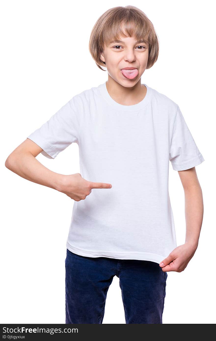 Little girl in blank t-shirt showing her tongue, isolated on white background. Portrait of happy teenager - design and people concept.