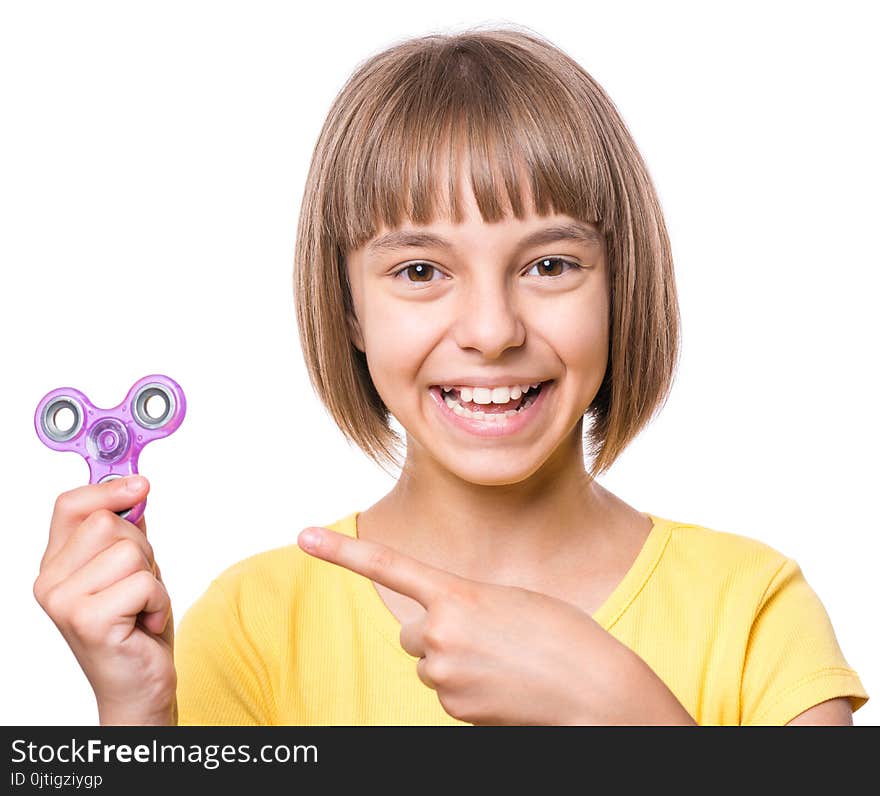 Young girl holding popular fidget spinner toy - close up portrait. Happy smiling child playing with Spinner, isolated on white background. Young girl holding popular fidget spinner toy - close up portrait. Happy smiling child playing with Spinner, isolated on white background.