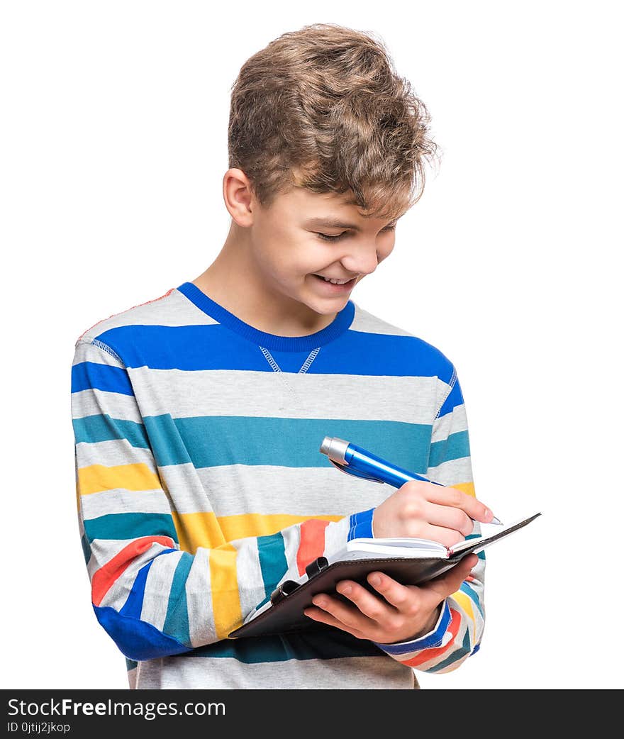 Portrait of caucasian smiling teen boy with notebook and blue pen writing something. Handsome funny teenager, isolated on white background. Happy student writing on note pad. Portrait of caucasian smiling teen boy with notebook and blue pen writing something. Handsome funny teenager, isolated on white background. Happy student writing on note pad.