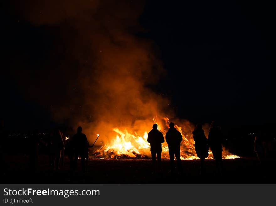 Silhouettes of people in frontof big easter fire