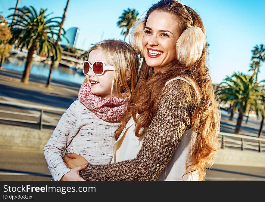 Happy mother and daughter travellers looking into distance