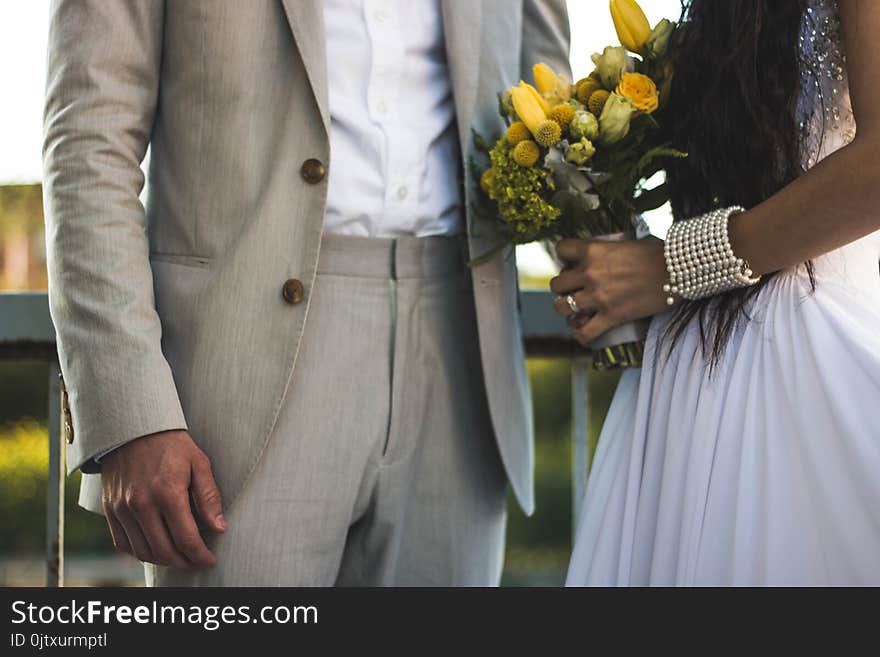 Woman Wearing White Dress And Holding Bouquet