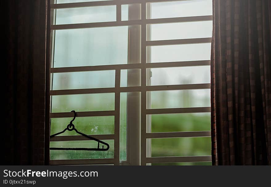 Black Clothes Hanger Hanged on Window