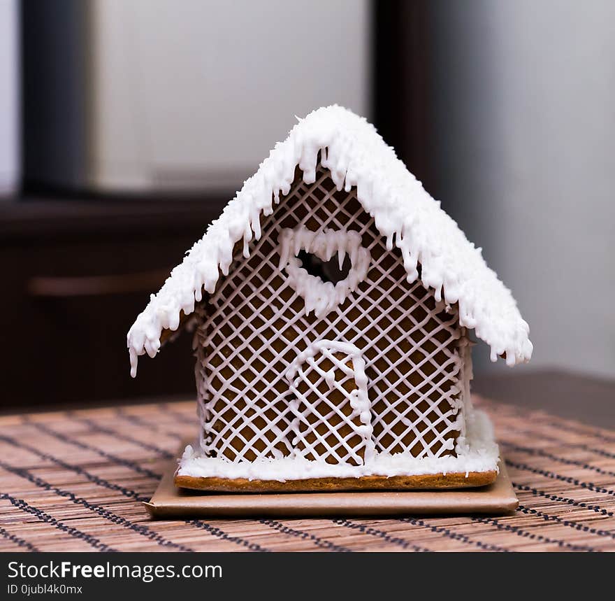 Beautiful appetizer sweet gingerbread house, white decoration. Christmas candy. Family home food. Winter background. Beautiful appetizer sweet gingerbread house, white decoration. Christmas candy. Family home food. Winter background.