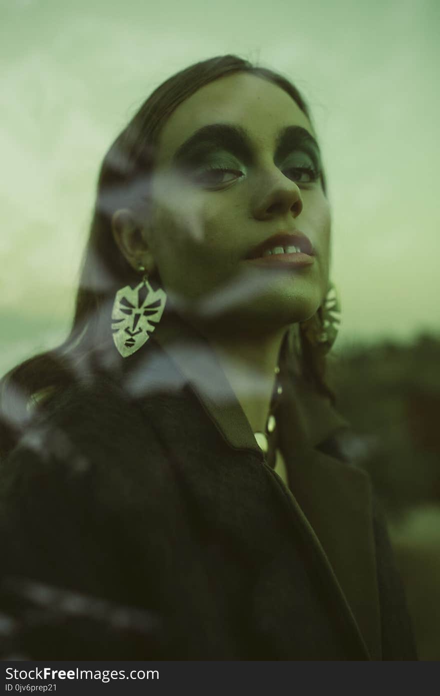 Woman Wearing Black Coat and Silver Earrings