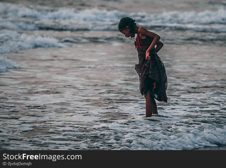 Girl Standing on Seashore