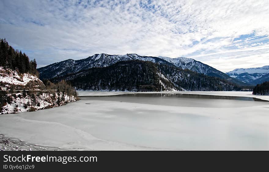 Snow Mountain With White Cloudy Sky