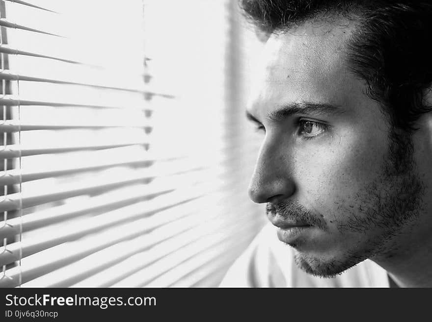 Man Looking Through Window