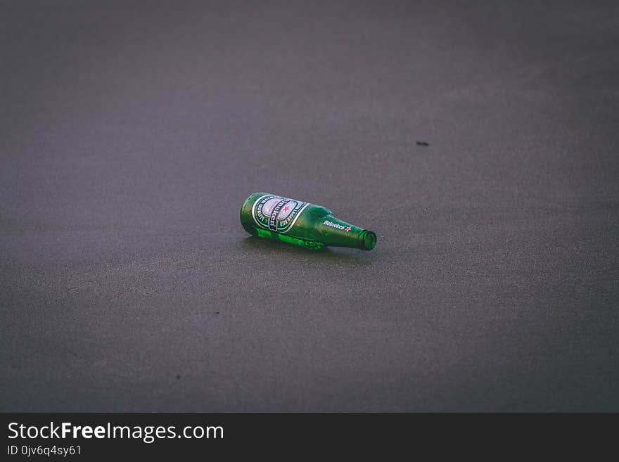 Empty Heineken Bottle on Ground