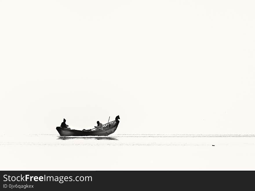 Two Person Riding Boat on Body of Water