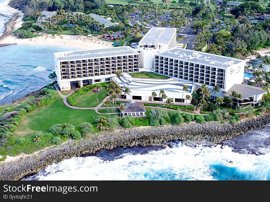 Aerial Photography of Building Near Cliff Beside Body of Water