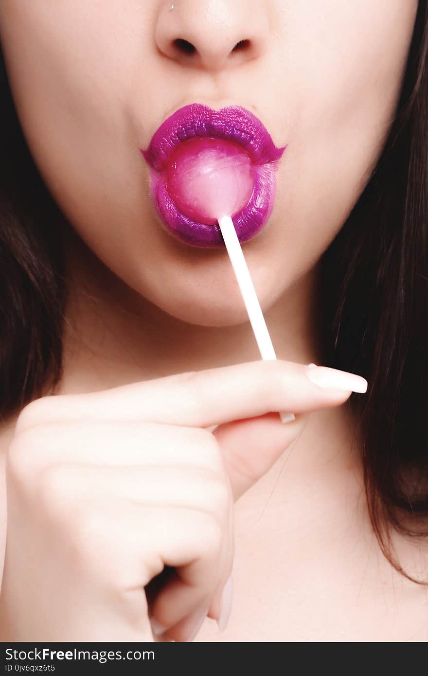 Woman With Pink Lipstick Licking Strawberry Lollipop