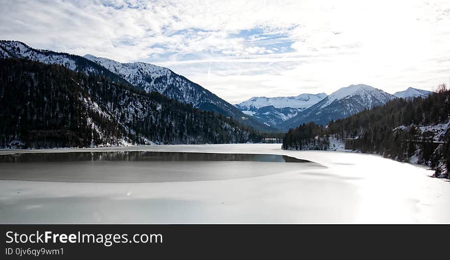 Landscape Photography of Body of Water Surrounded by Green Leaved Trees Near Mountains