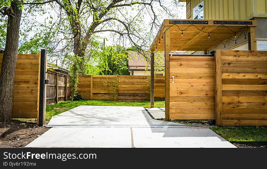 Photo of Opened Brown Wooden Sliding House Gate