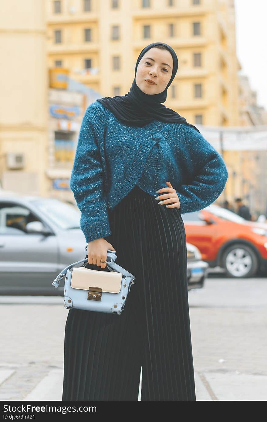 Woman Wears Blue and Black Sweater With Pants