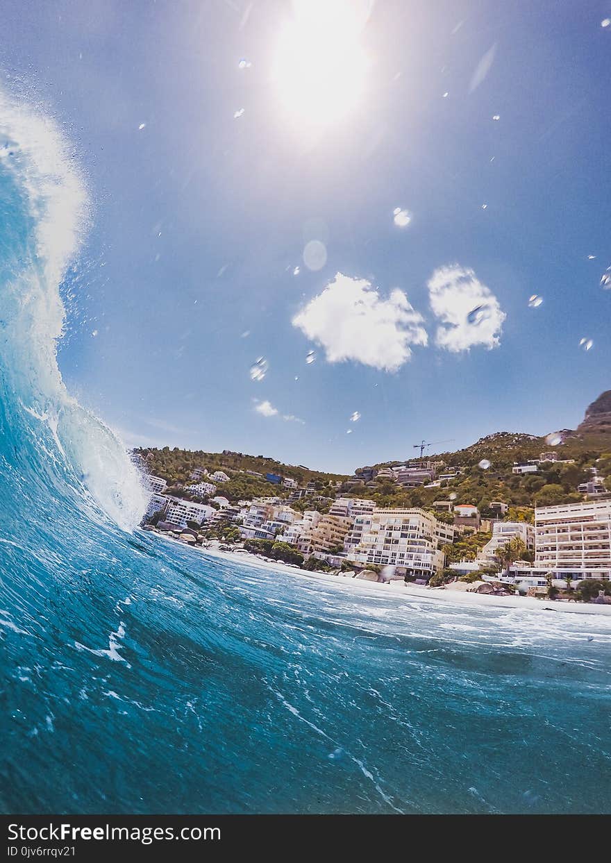 Closeup Photography of Sea Wave Near Concrete Building at Daytime