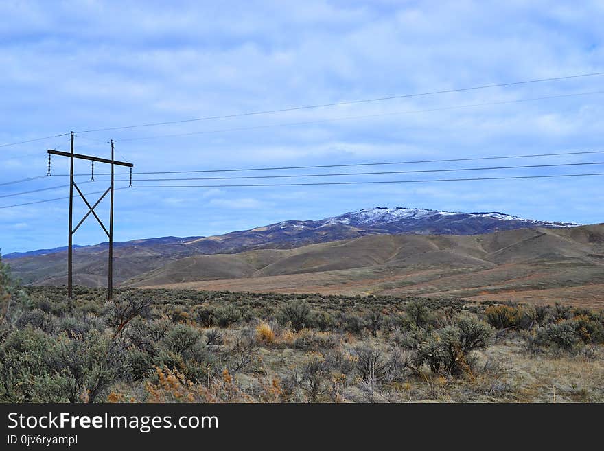 Brown Electric Post on Green Grass Field