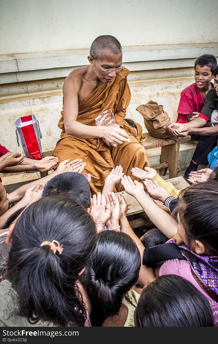 Monk Handing Towards Kids