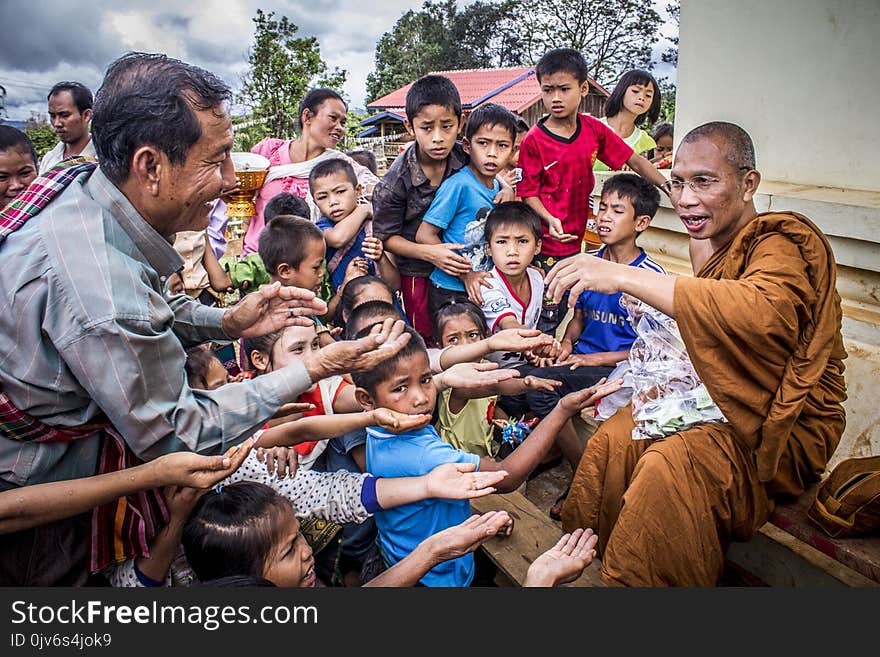 Group of People Begging on Monk