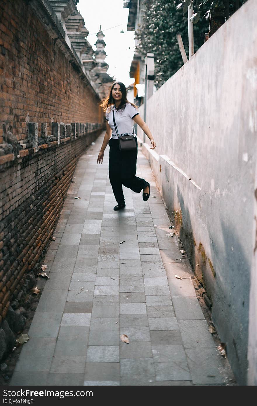 Woman Wearing White Shirt and Black Pants