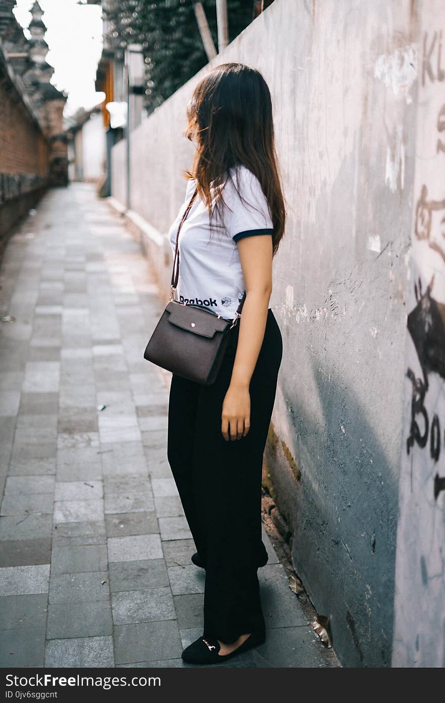 Woman Wearing Black and White T-shirt and Black Pants