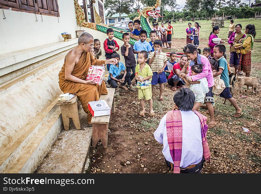 Group of Children in Front of Monk at Daytime