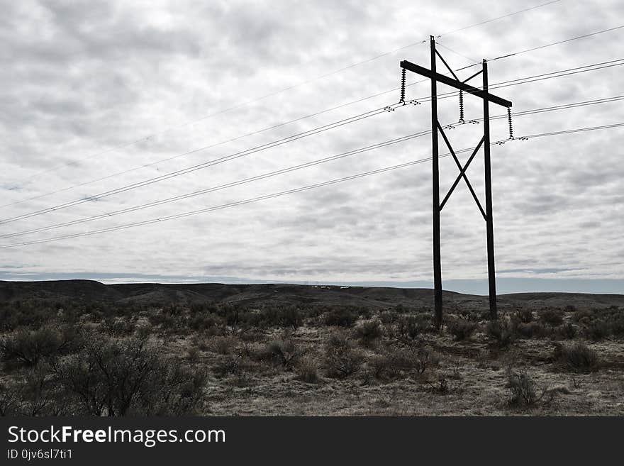 Photograph of Electrical Post on Cloudy Day