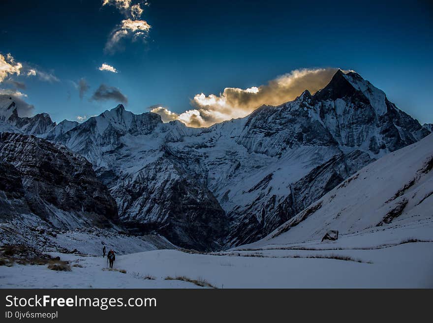 Person Walking in Snow Mountain