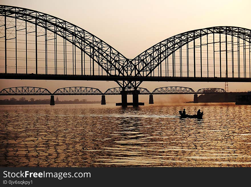 Black Metal Bridge Near on Body of Water