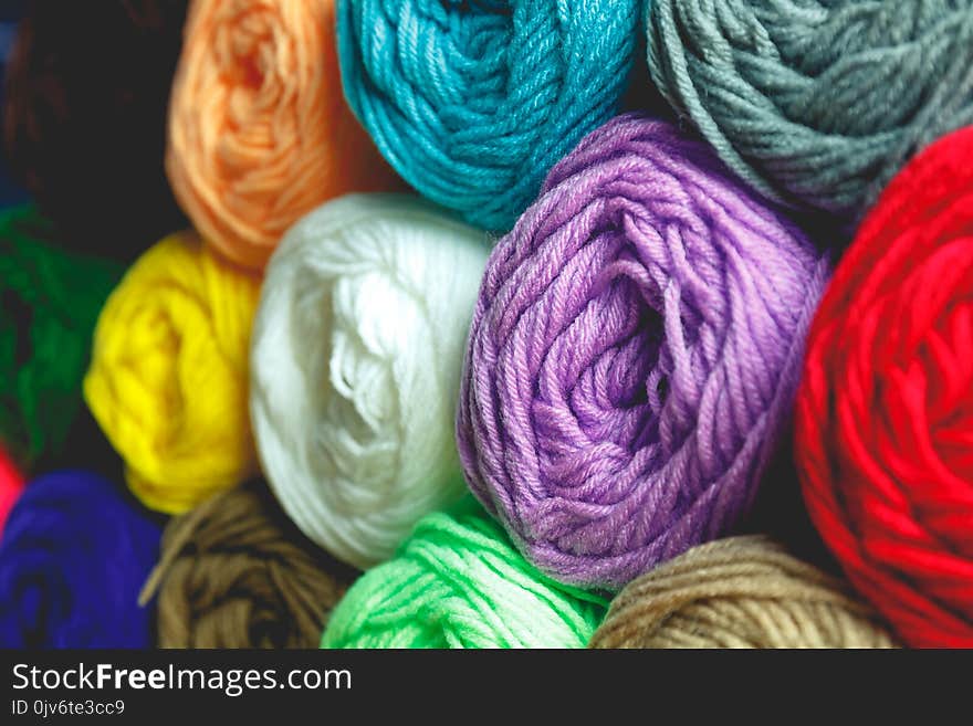 Close up colorful wool detail on wooden table background and concept