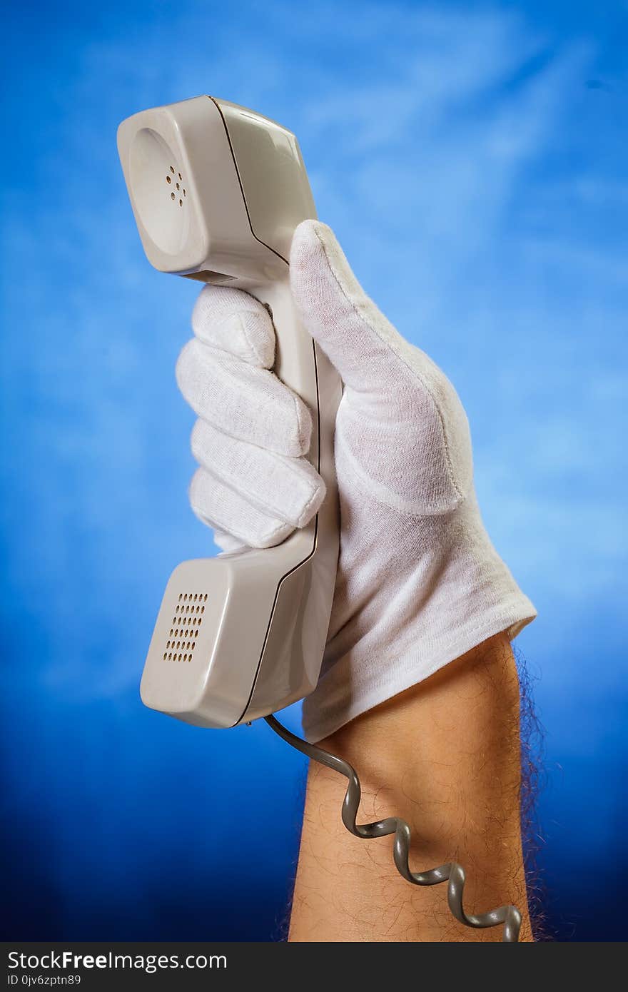 Male Hand In White Glove Holding Landline Phone Receiver