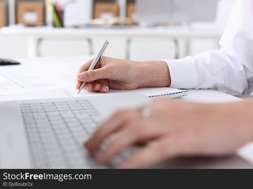 Businesswoman in the office holds her hand on the laptop makes financial analysis and calculation of expenses and incomes of the enterprise forms a report on the work done for the reporting period. Businesswoman in the office holds her hand on the laptop makes financial analysis and calculation of expenses and incomes of the enterprise forms a report on the work done for the reporting period.