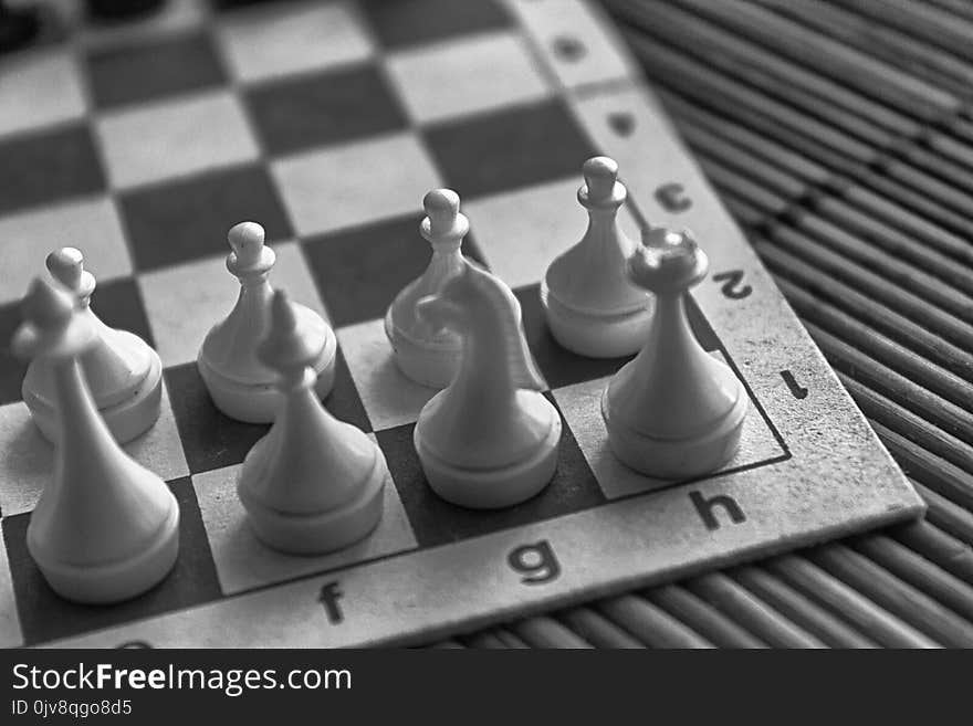 Monochrome Wooden Chess Board and steel chess pieces, on board.