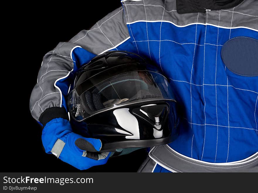 Racing driver body-part with helmet isolated in black. Racing driver body-part with helmet isolated in black