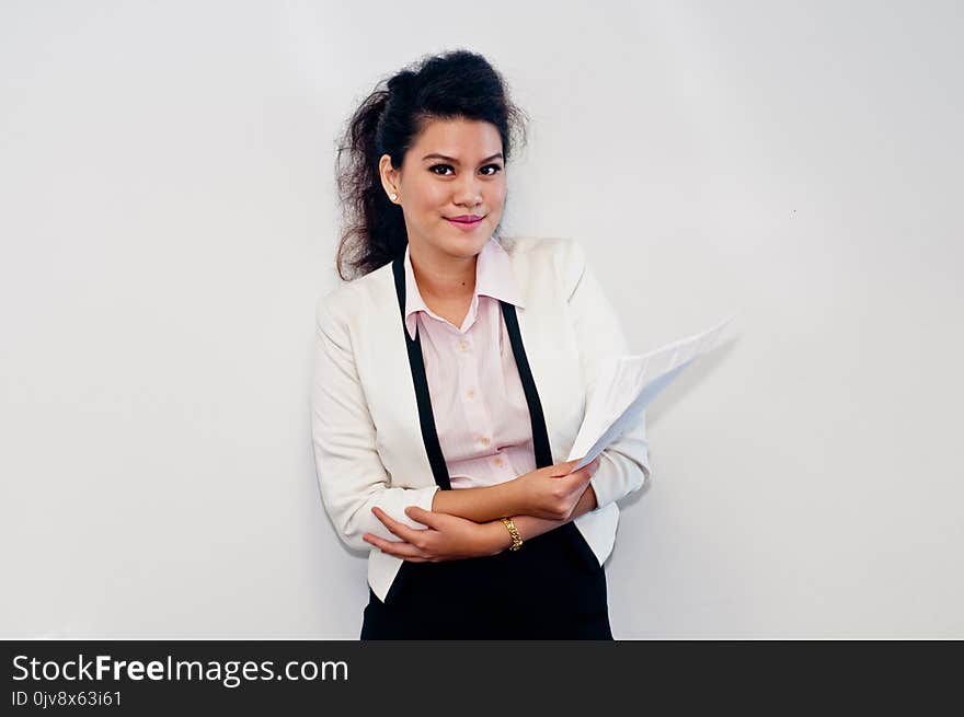 Woman holding business contract on white background