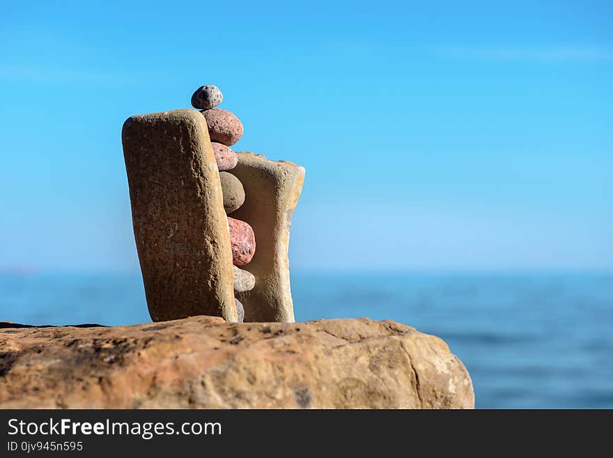 Balancing several of stones on the seashore. Balancing several of stones on the seashore