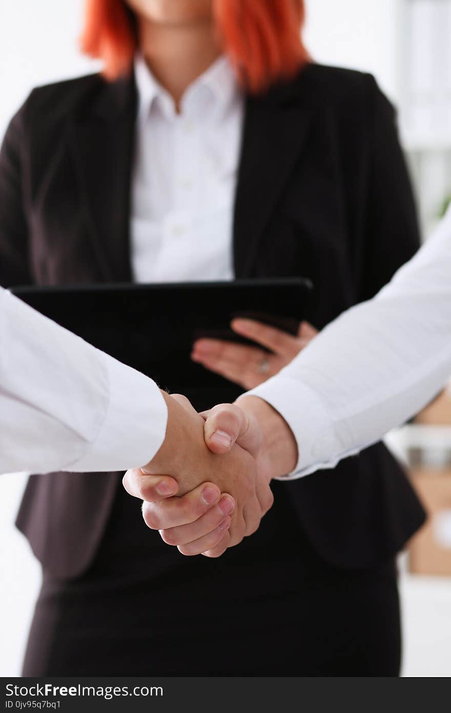 Smiling man in suit shake hands as hello in office portrait. Friend welcome mediation offer positive introduction greet or thanks gesture summit participate approval strike arm bargain concept