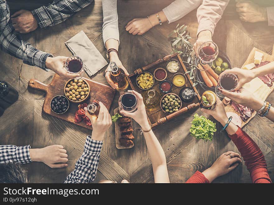 Group of people having meal togetherness dining toasting glasses