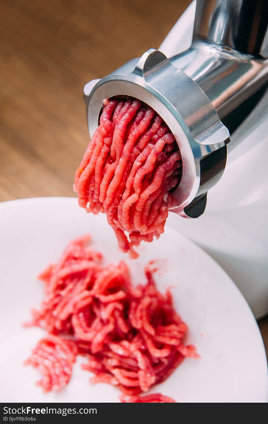 Meat grinder - process of grinding meat. Beef mince in mincing-machine.