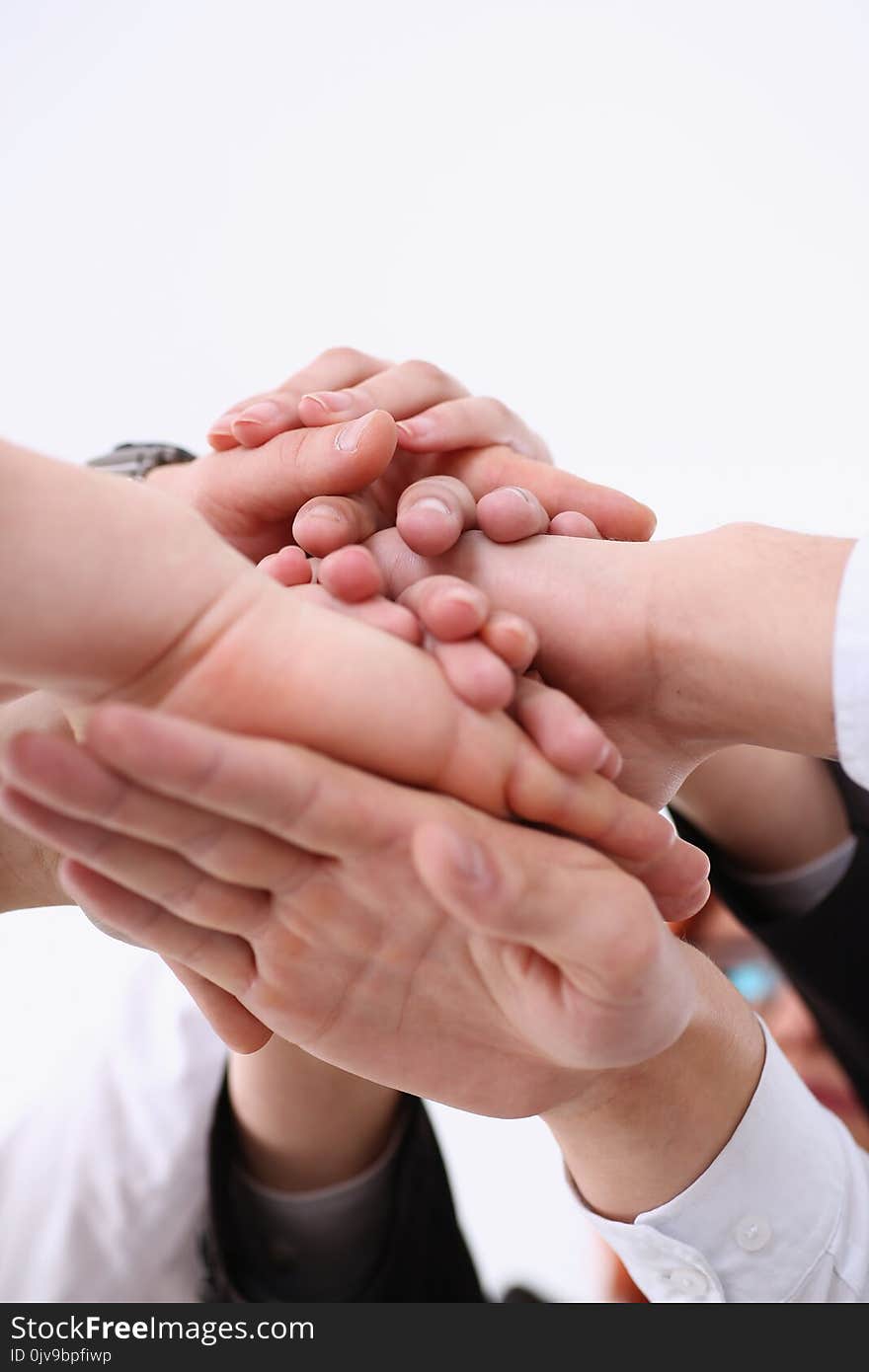 Group of people in suits crossed hands in pile for win closeup. White collar leadership high five cooperation initiative achievement, corporate life style friendship deal heap stack concept. Group of people in suits crossed hands in pile for win closeup. White collar leadership high five cooperation initiative achievement, corporate life style friendship deal heap stack concept