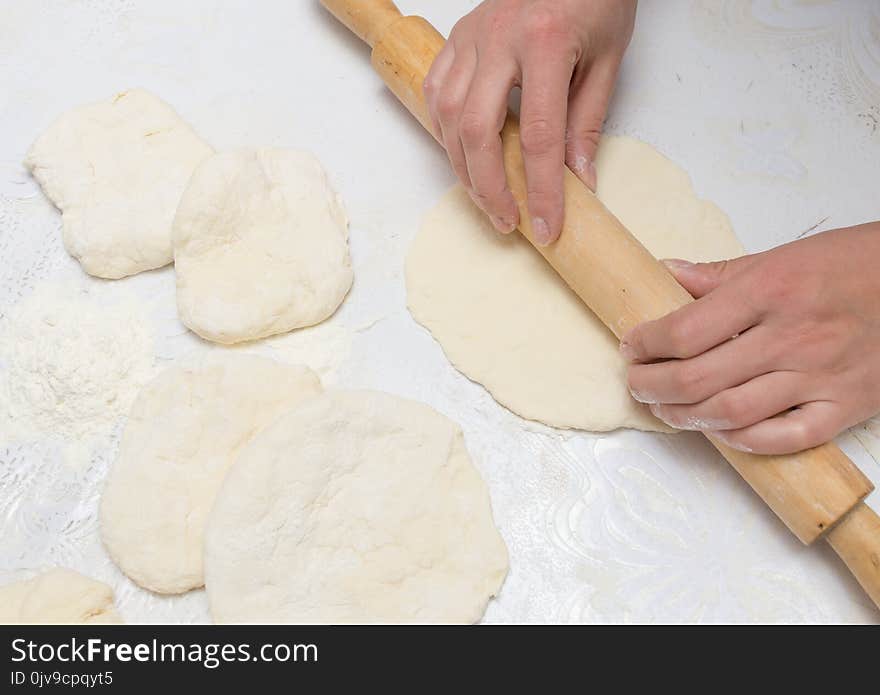 Rolling dough with a rolling pin . Photos in the studio