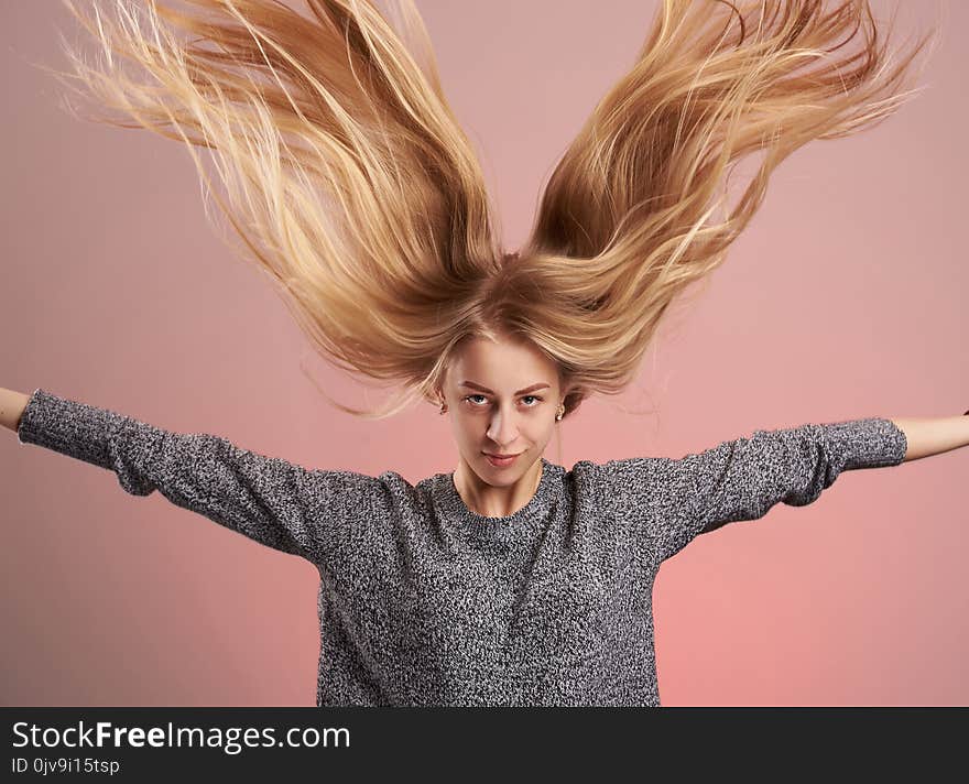 Young blonde woman with hair up isolated on pink background. Young blonde woman with hair up isolated on pink background