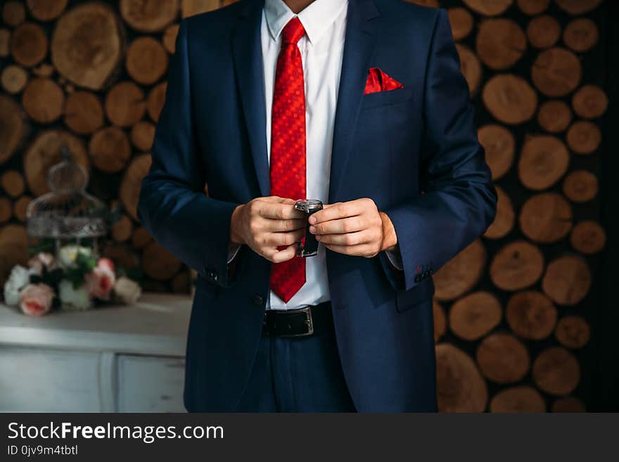 Businessman checking time on his wristwatch. men`s hand with a watch.