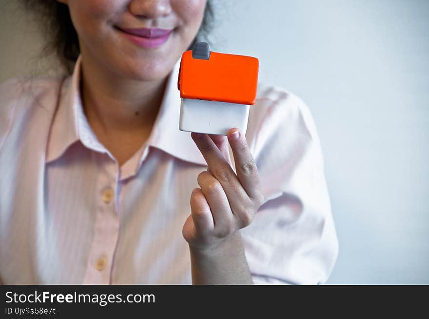 House toy model is hold by business woman hand