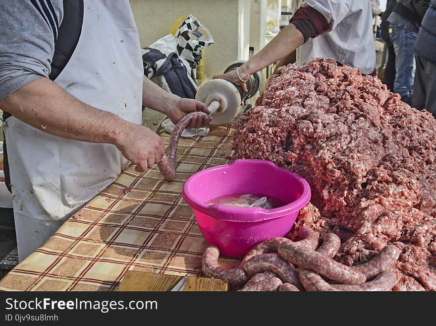 The butcher makes homemade sausages in the open air in a traditional way. The butcher makes homemade sausages in the open air in a traditional way.