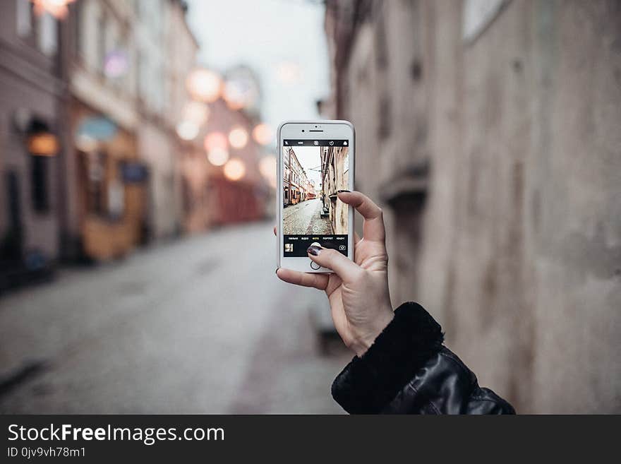 Lublin, Poland the view of the street in old town, fron mobile phone. phone in the right hand,