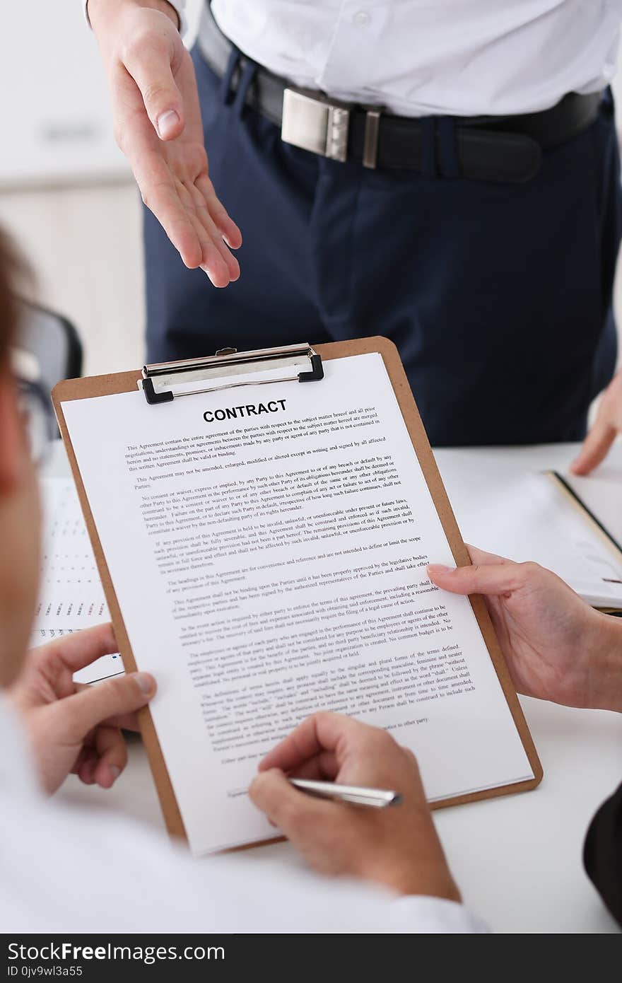 Male arm in shirt offer contract form on clipboard