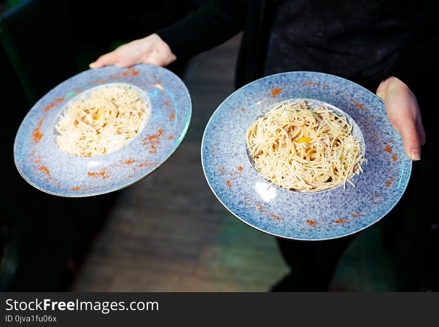 Pasta Carbonara. Spaghetti with bacon, parsel and parmesan cheese in blue plate. Italian food concept.