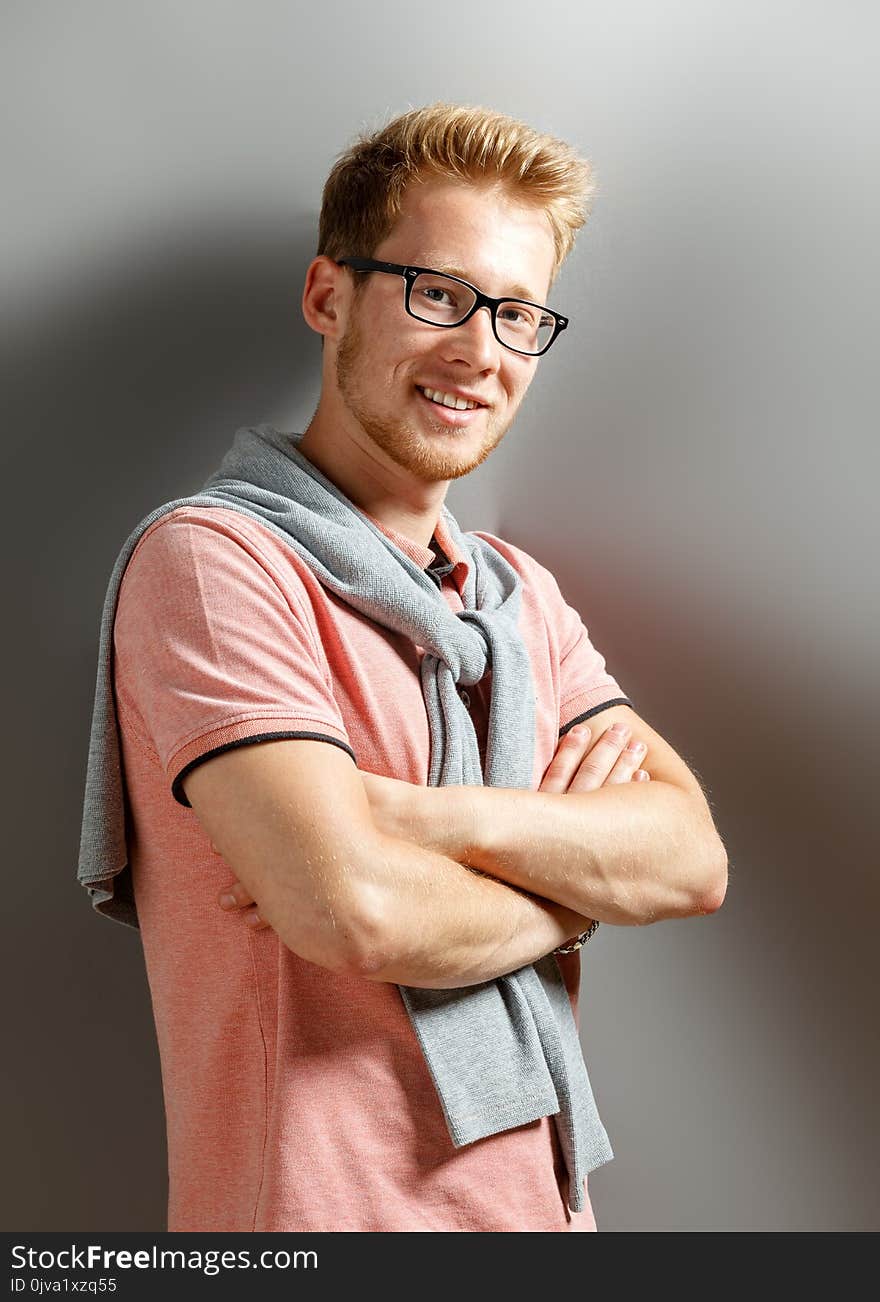 Young man on grey background.